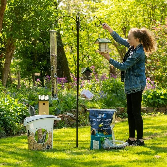Een vrouw hangt verschillende voedersystemen op